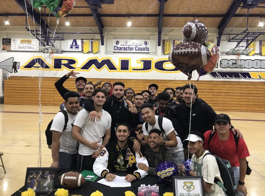 Signing+as+a+college+athlete+is+an+important+event+for+Tariq+%28shown+with+his+teammates%29.+He+was+one+of+five+students+who+publicly+signed+for+the+college+of+their+choice+in+May.