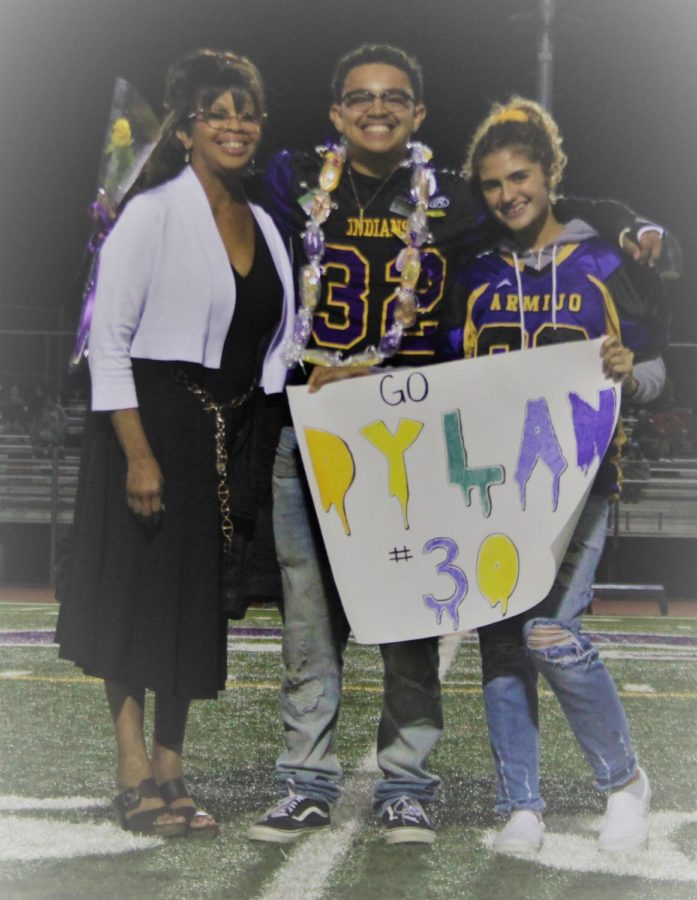 Dylan, flanked by two of his biggest fans, looks back fondly on memories during Senior Night.