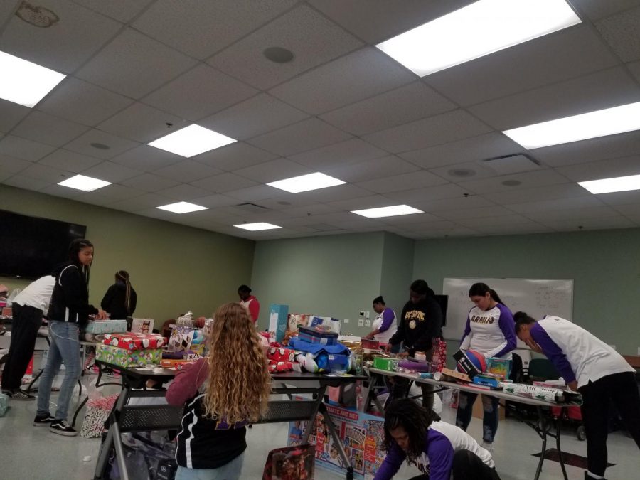 The Lady Royals Basketball  Program  wrapping  Christmas presents for the less fortunate on 12/16/19.. 