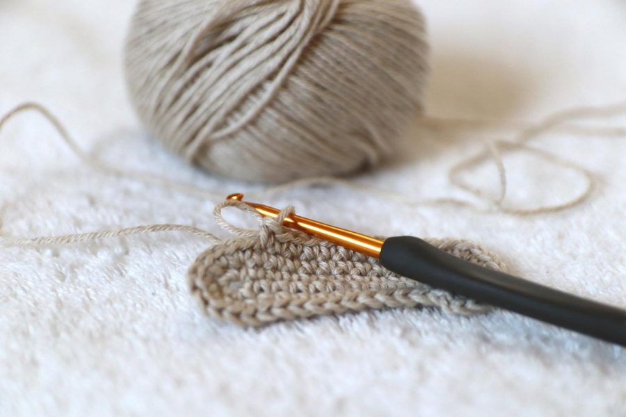 With a hook and a ball of yarn, members create.
