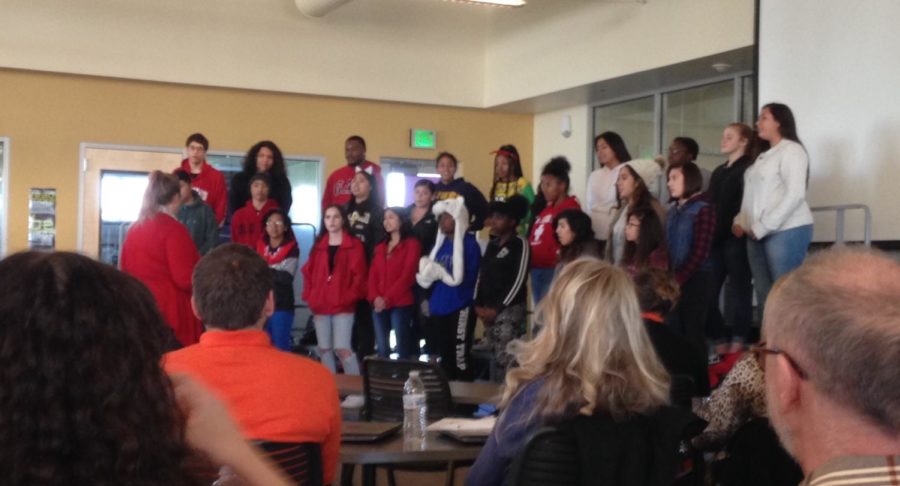 In anticipation of their December 13 performance, the AHS choir sings holiday songs to the AHS faculty.