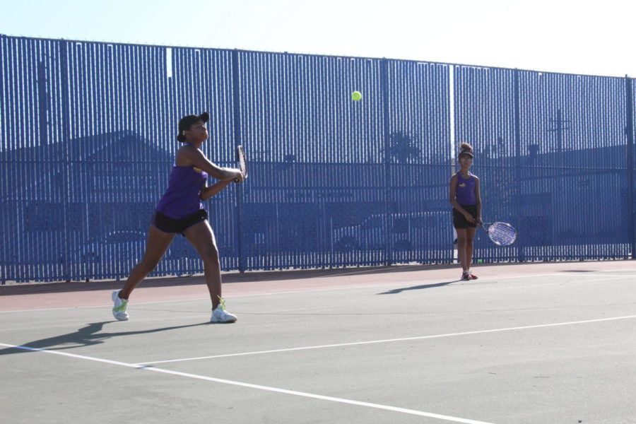 Two players playing tennis