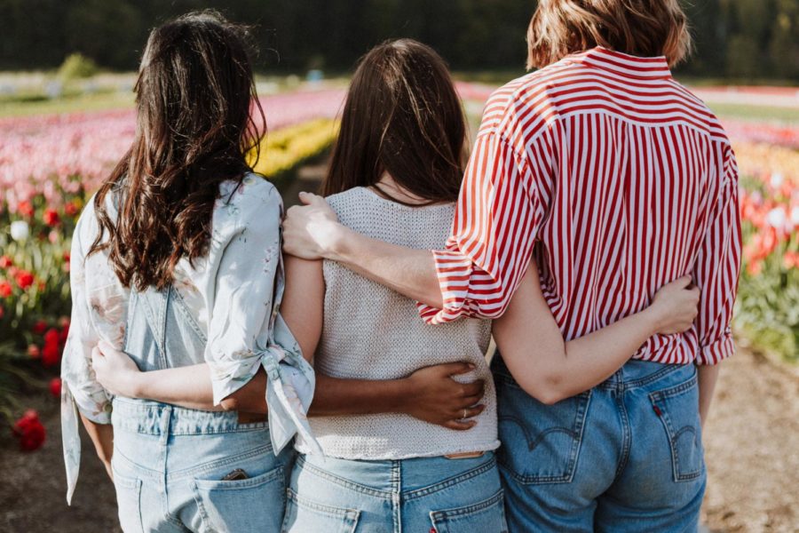 Three women having each other's backs.