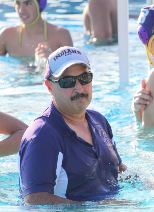 Coach Marin joins his players in the pool so he can show them what to do.