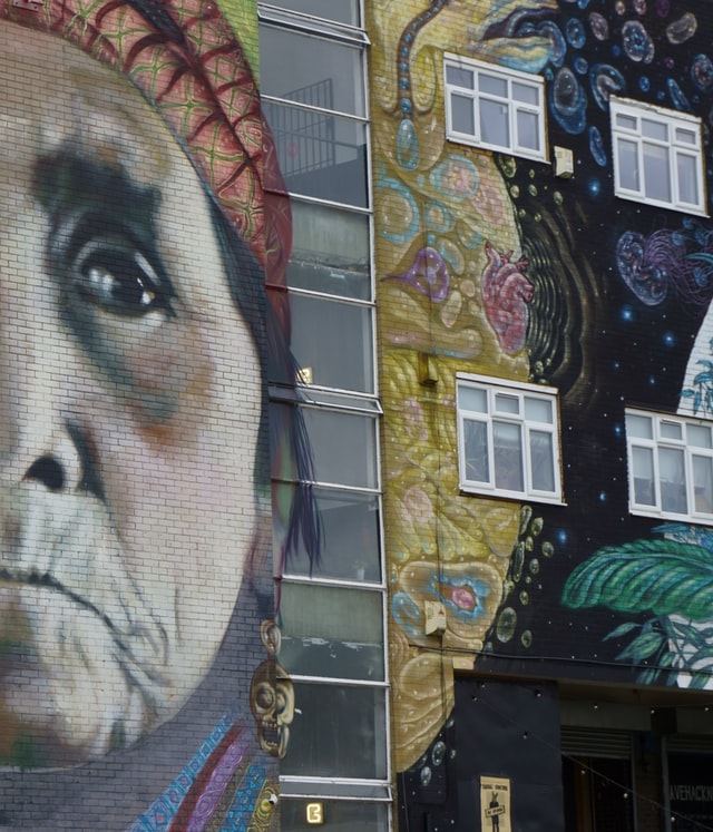 Graffiti of a Native American woman on the side of a building in East London.