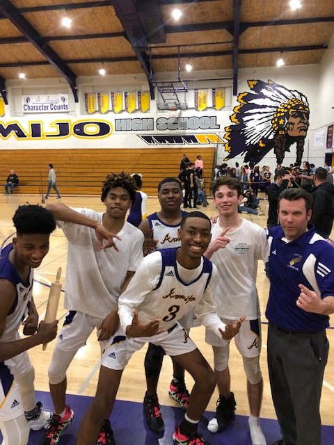 Coach Stoll (right) is joined by a proud team.